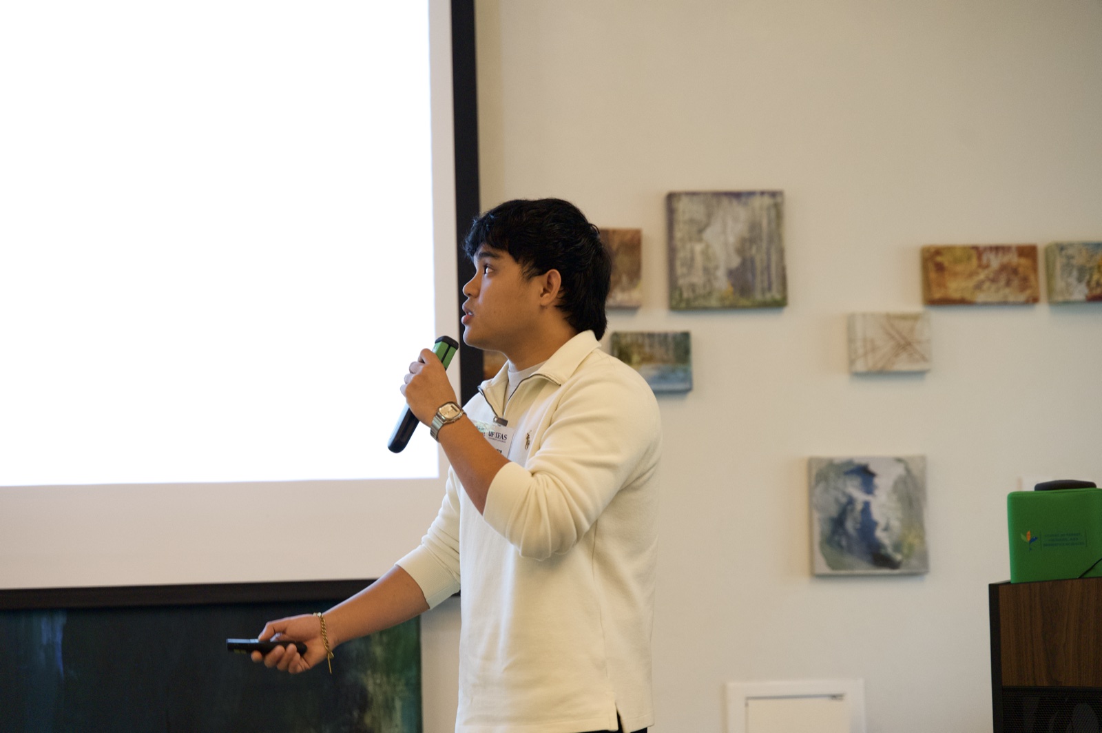 Angelo De Castro pointing to a slide during his oral presentation